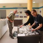 People reviewing items for display cases in museum
