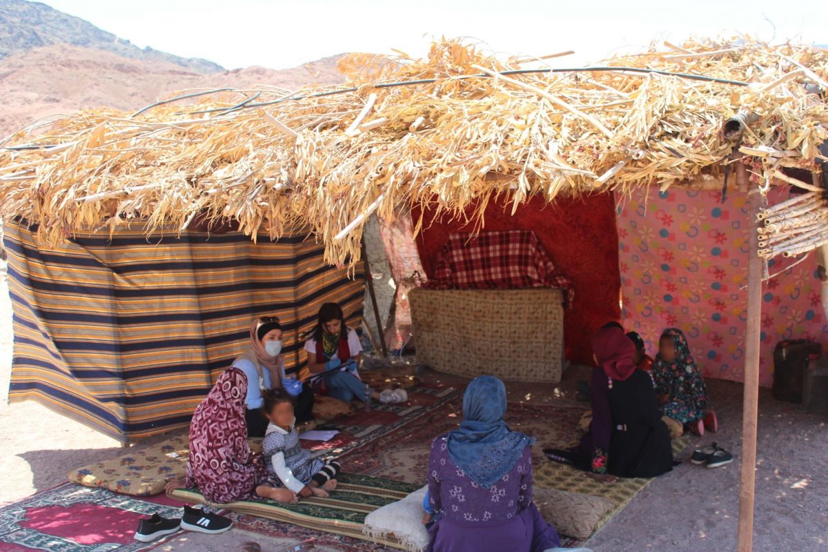 Women sitting in camp