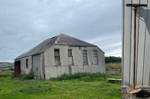 Photograph of a dilapidated building that was once the generator house in Borth