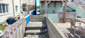 Storm board fitted into a alleyway between two houses