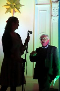 A man walks up to the microphone to be tell a story