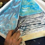 An old umbrella painted with a stormy sea scene