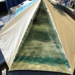 One panel of an old umbrella painted with a stormy sea scene