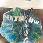 Tiny laundry hangs in a broken umberella