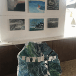 Storm paintings hang next to the storm umbrella