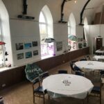 Art exhibition hung along the wall of the chapel