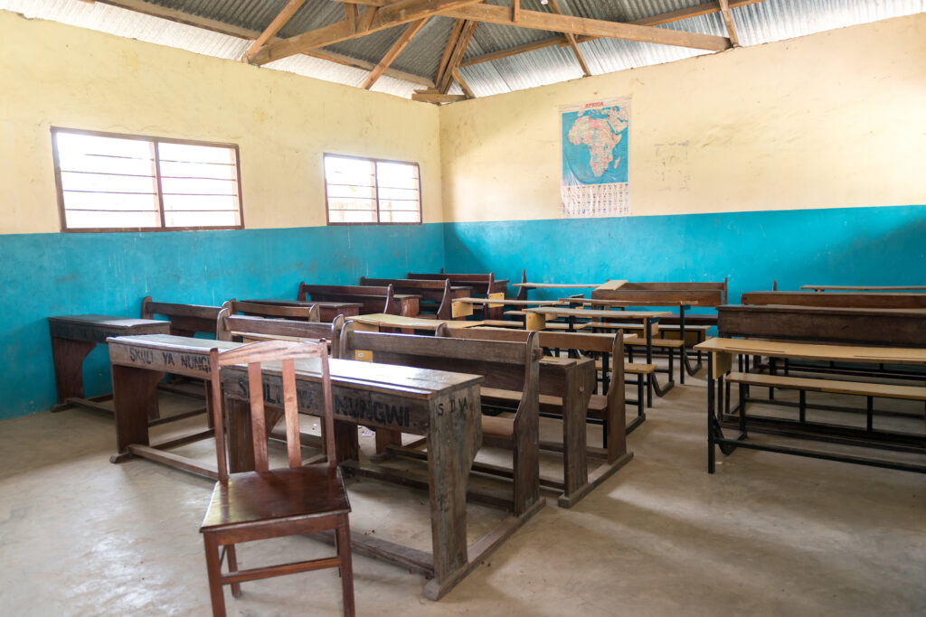 simple class room in village school with wooden desks and chairs in Zanzibar, Africa