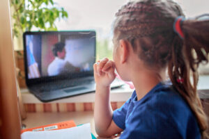 English class with student tutor online. Girl studying English language with student at home