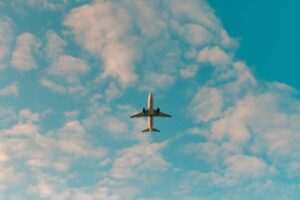 Plane against a blue sky with clouds