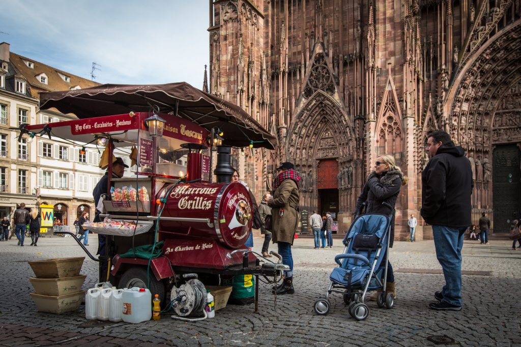 A red chestnut stall with Strasbourg cathedral in the background