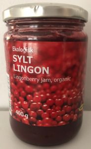 Glass jar of red jam with SYLT LINGON label and metal lid