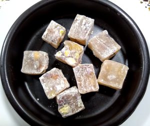 Black dish containing yellow cubes of turkish delight