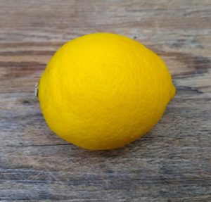 single lemon fruit on wood background