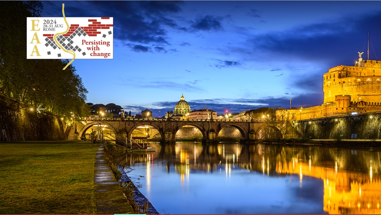 Photo of Rome at dusk showing a bridge crossing a river and a domed building lit up by uplighting