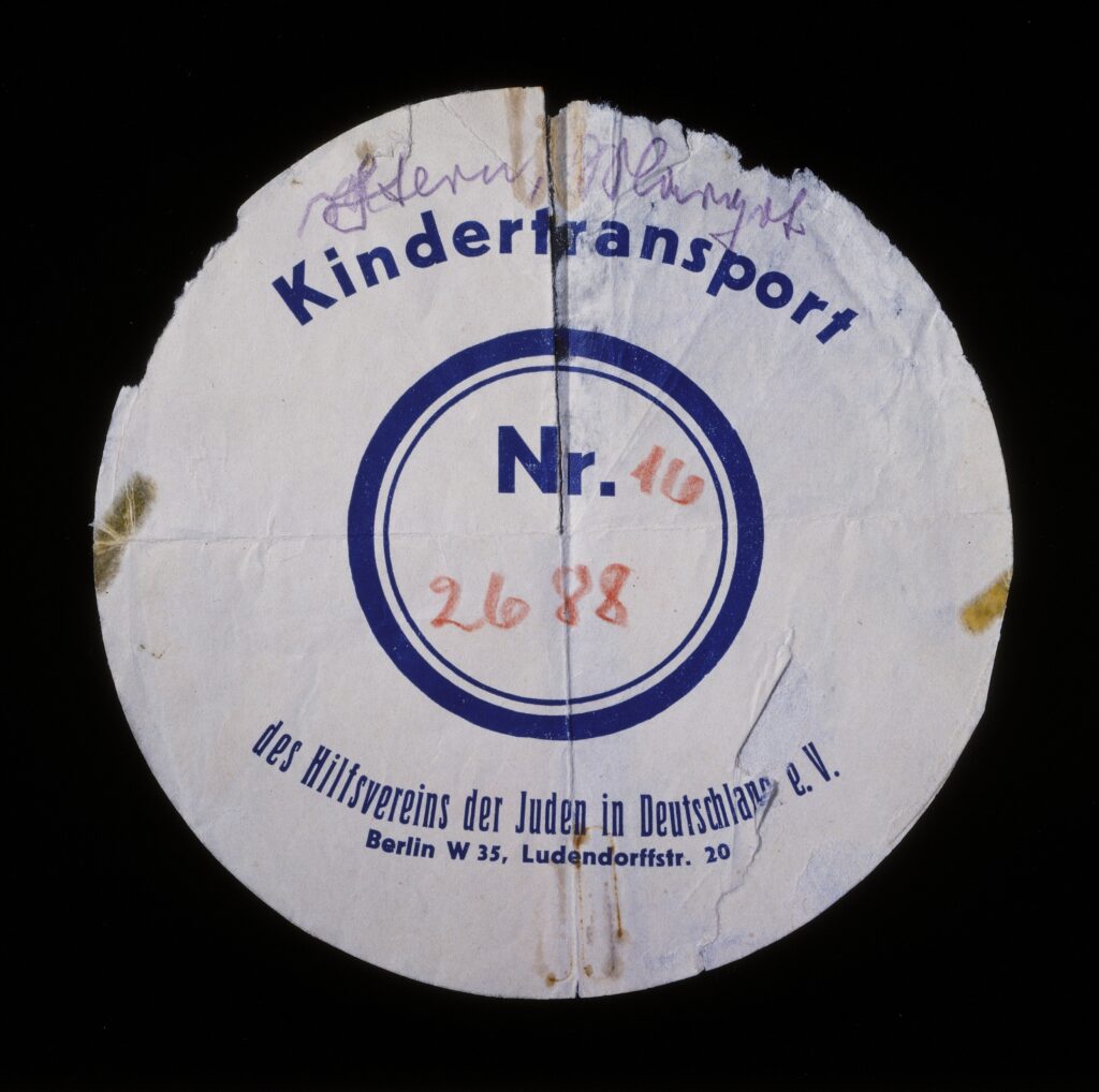 Circular label removed from the suitcase used by Margot Stern when she was sent on a Kindertransport to England. Copyright: United States Holocaust Memorial Museum Provenance: Margot Stern Loewenberg Source Record ID: Collections: 1995.21.2