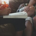 An image of a notebook balanced on a person's knees