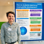 Photo of Denis Persichini next to his research poster at the conference