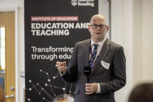 Man in a suit speaking to a group