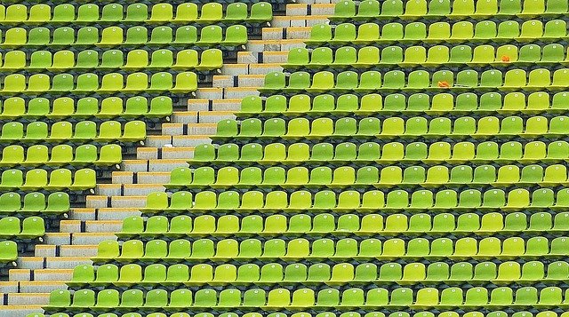 colour photograph of empty green stadium seats