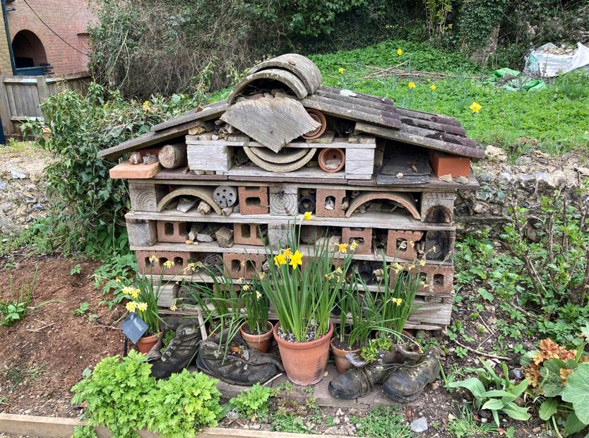 a bee hotel made out of old tiles and bricks