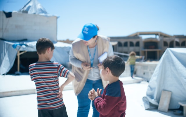 Children speaking to an aid worker