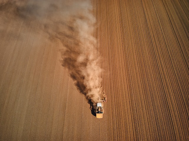 Aerial view of tractor in a dusty field