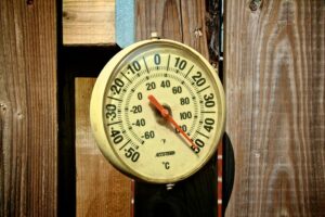 Outdoor thermometer showing temperature in excess of 50 degrees Celsius.