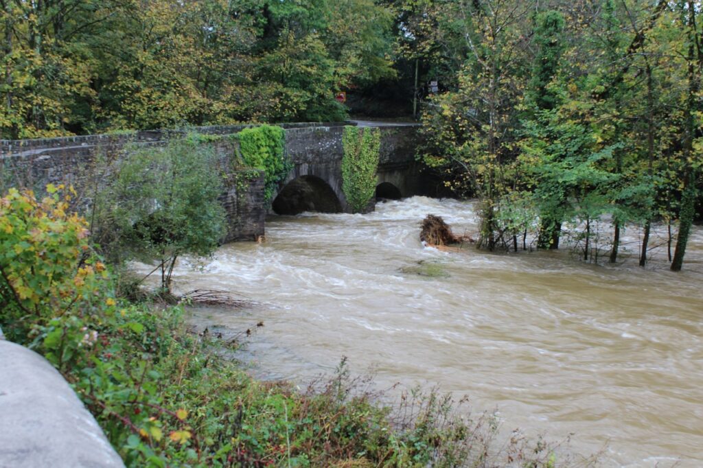 The river flowing under Henllan Bridge in Wales. The water level is very high.