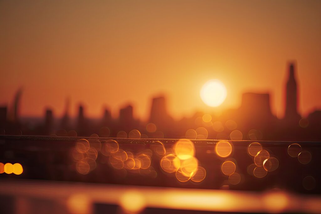 A blurry golden picture of sunset in the city to represent hot temperatures