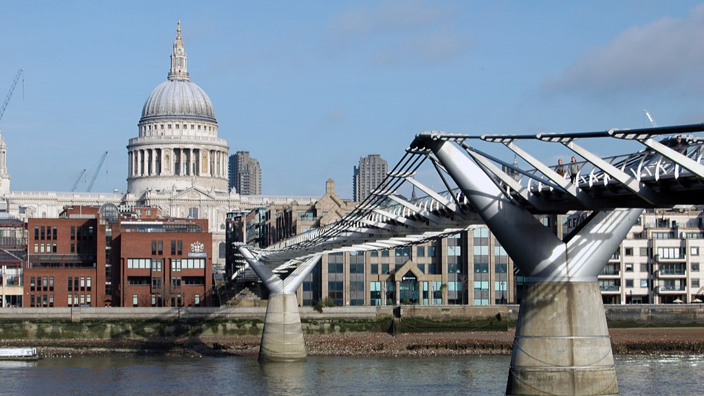 View on the Millenium Bridge and St. Pauls Cathedral from the Modern Tate Gallery side of the river Thames, London, UK.