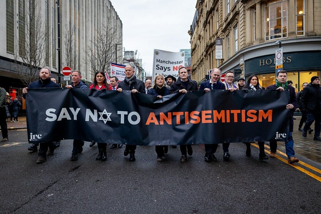 Security Minister Tom Tugendhat joins a march against antisemitism in Manchester