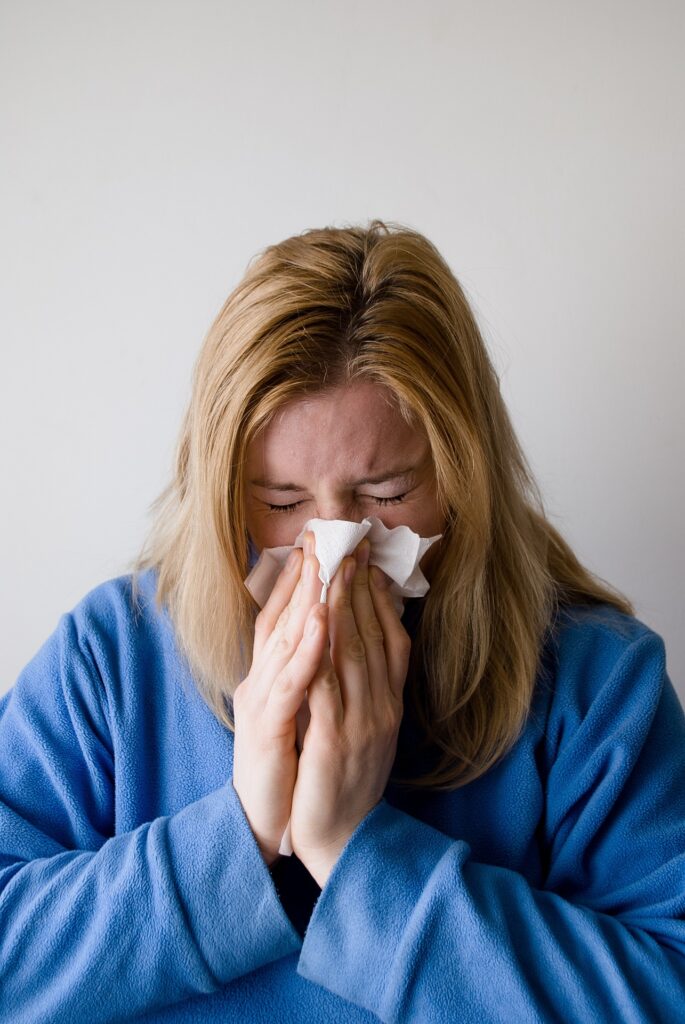 A woman blowing her nose