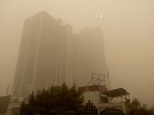 A large building obscured by thick, orange-tinted smog