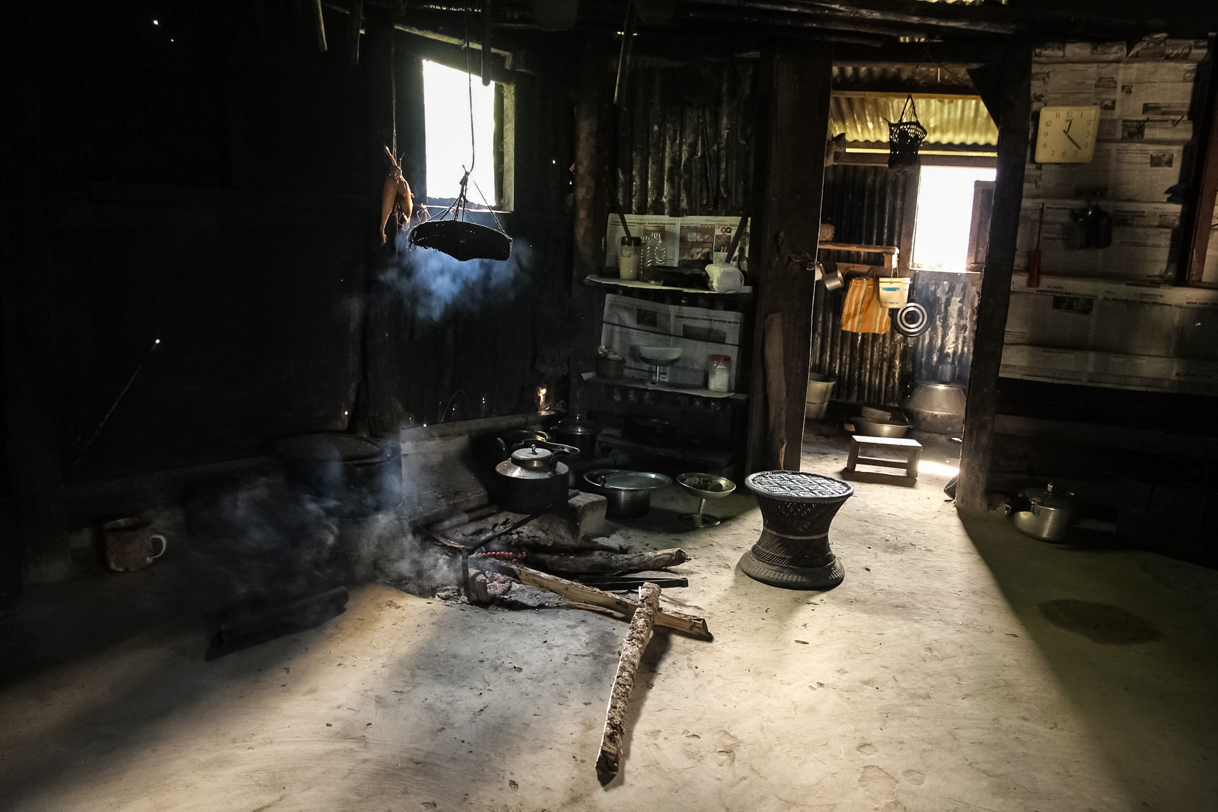 A kitchen in a traditional house with smoke from a tea kettle heated with wood fire in a village in Nagaland.