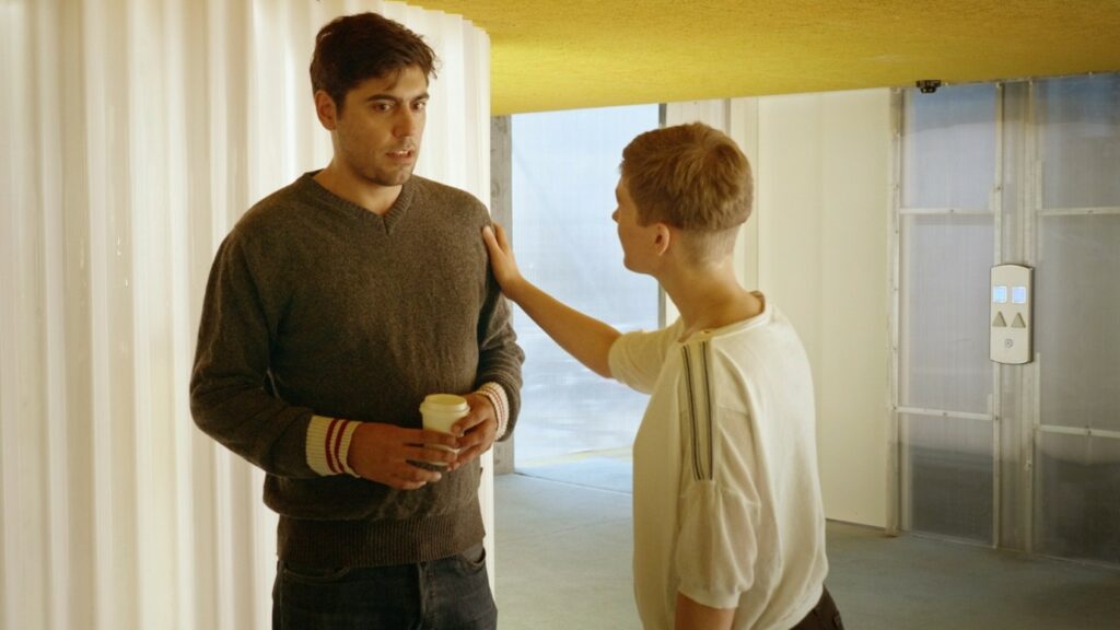 Person stroking another person's shoulder