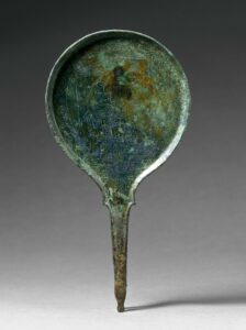 A bronze mirror with an engraving