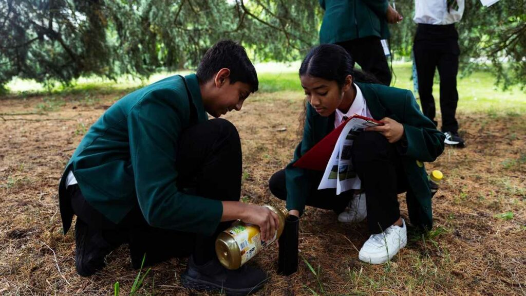 Two children in an outdoor learning garden.