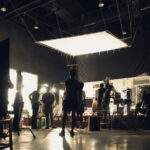 Silhouette of people working in big production studio