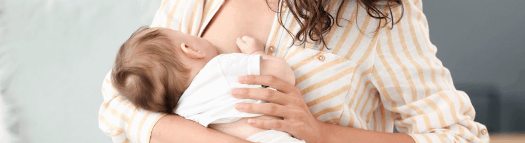 Young mother breastfeeding an infant